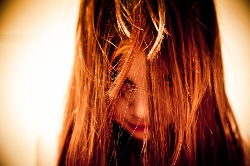 woman with long hair looking down