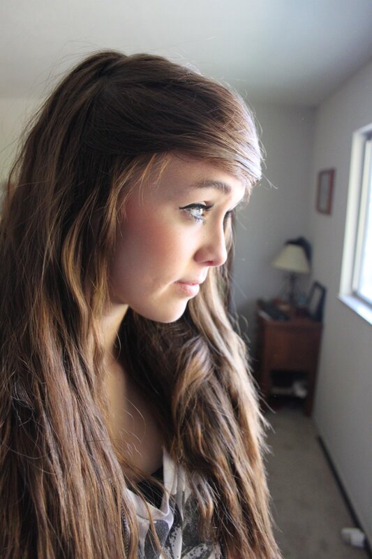 woman with long hair looking out window