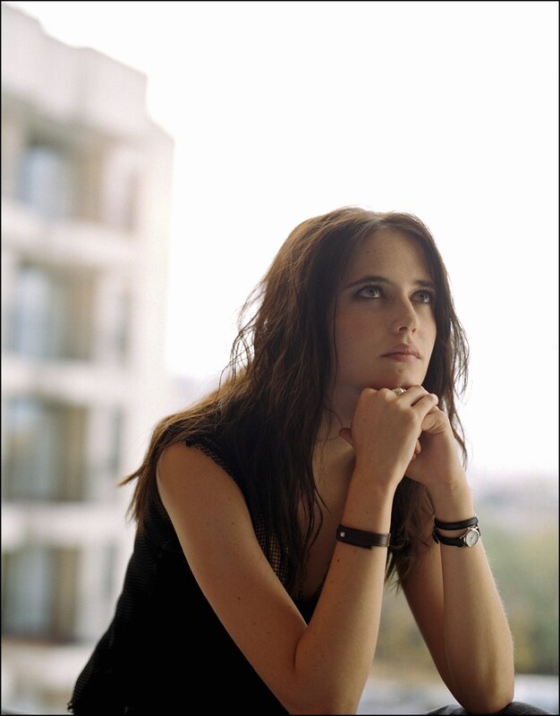 woman with long hair looking thoughtfully