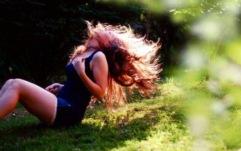 woman with long hair on grass