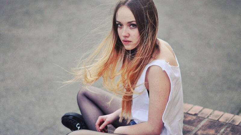 woman with long hair sitting
