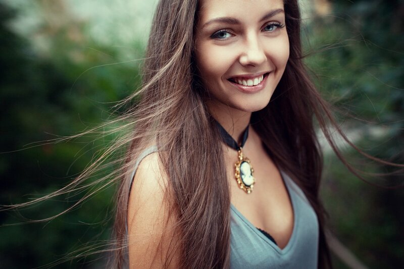 woman with long hair smiling