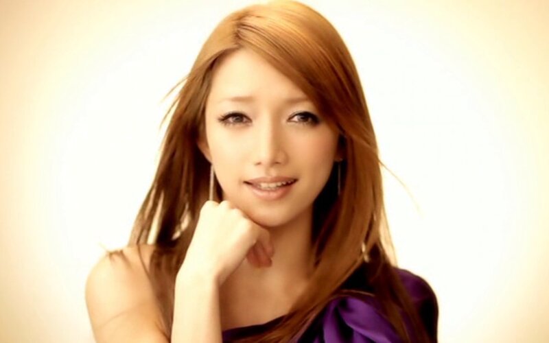 woman with long hair smiling