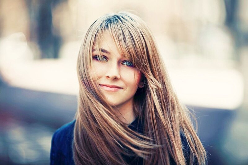 woman with long hair smiling