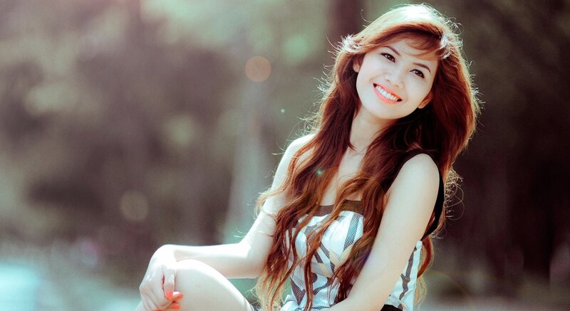 woman with long red hair smiling