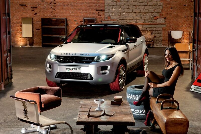 Woman with luxury SUV in warehouse