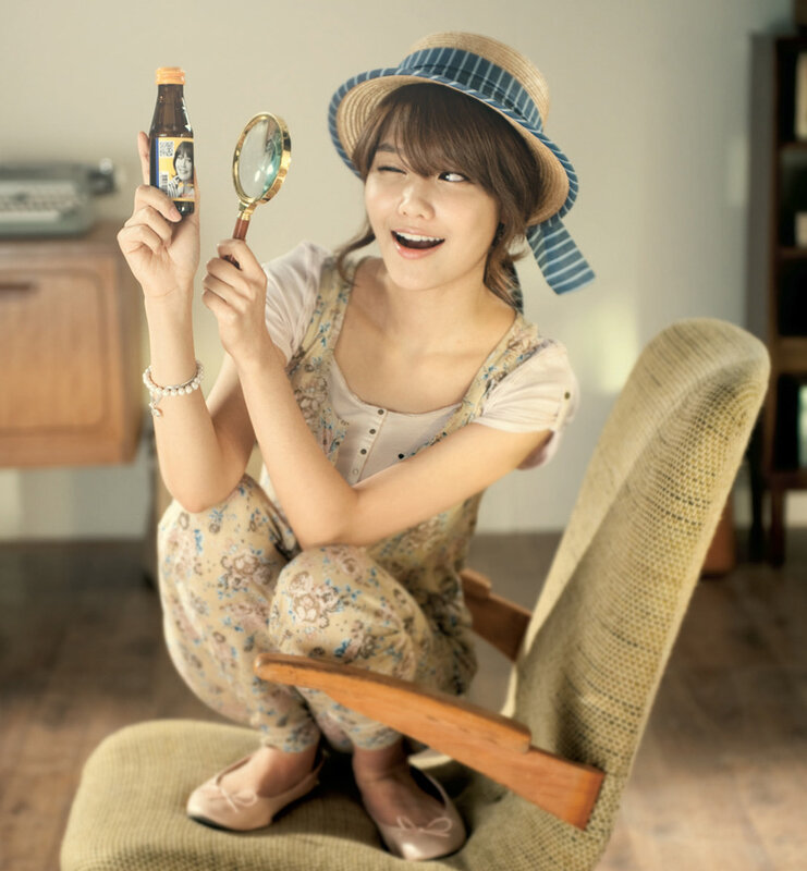 woman with magnifying glass and bottle