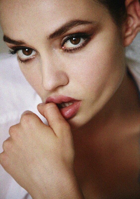 woman with makeup and hand on chin