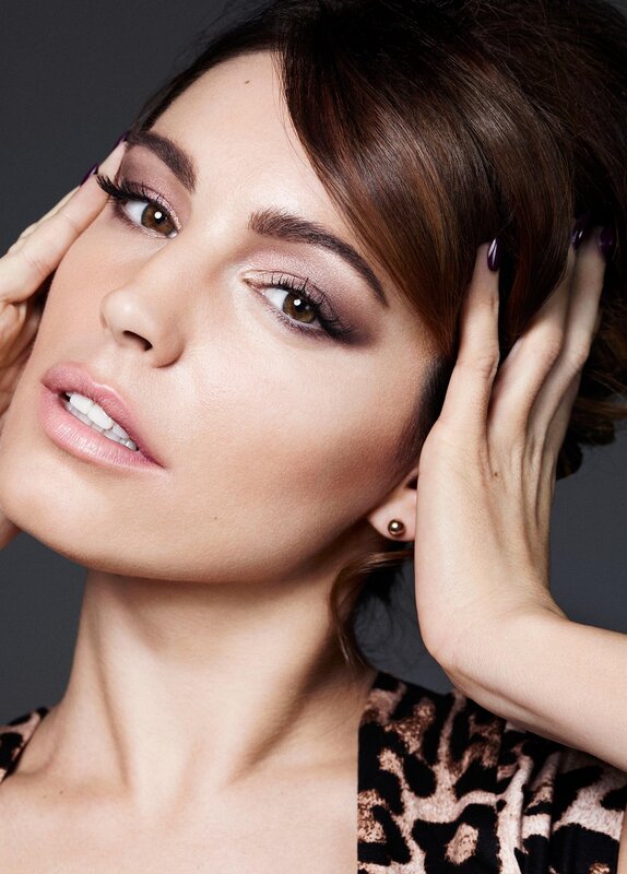 woman with makeup and hands on face
