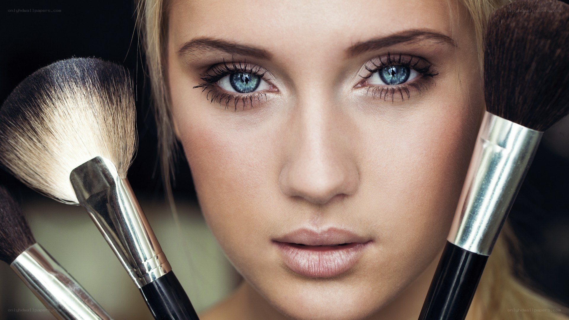 woman with makeup brushes
