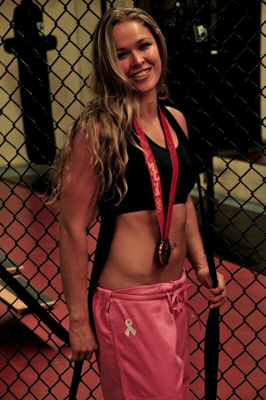 woman with medal in gym