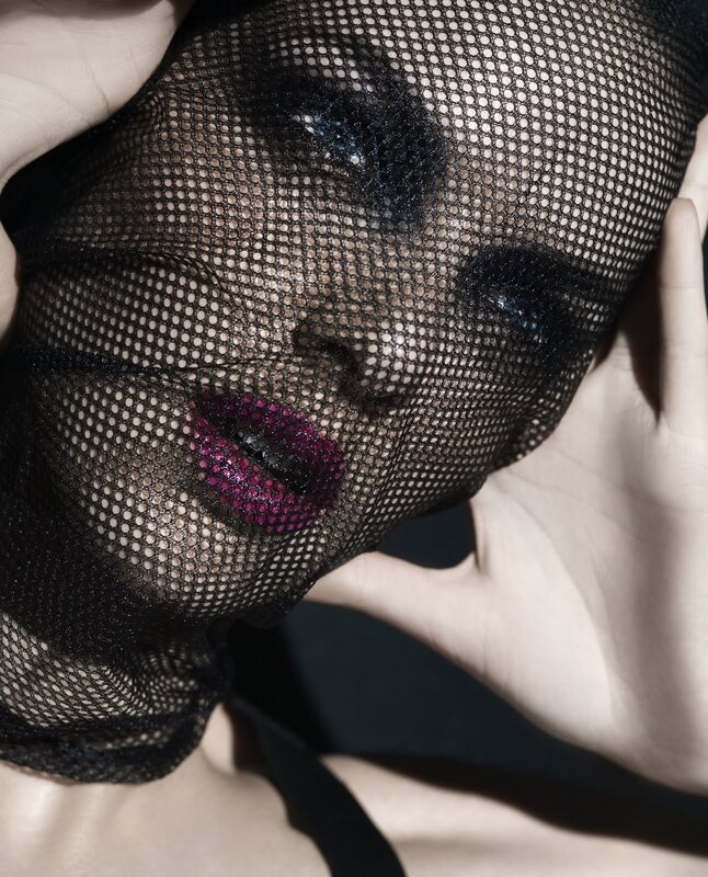 woman with mesh veil and purple lips