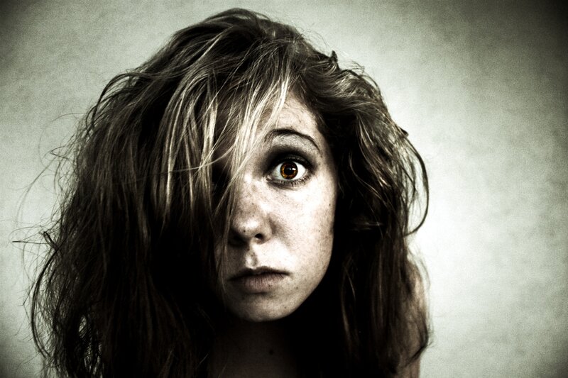 woman with messy hair and intense gaze