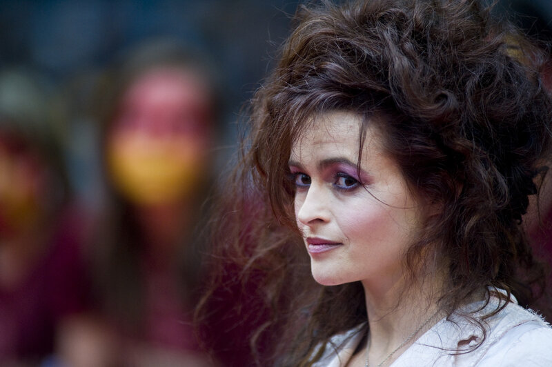 woman with messy hair and purple makeup