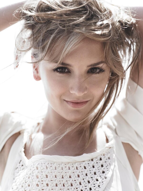 woman with messy hair smiling