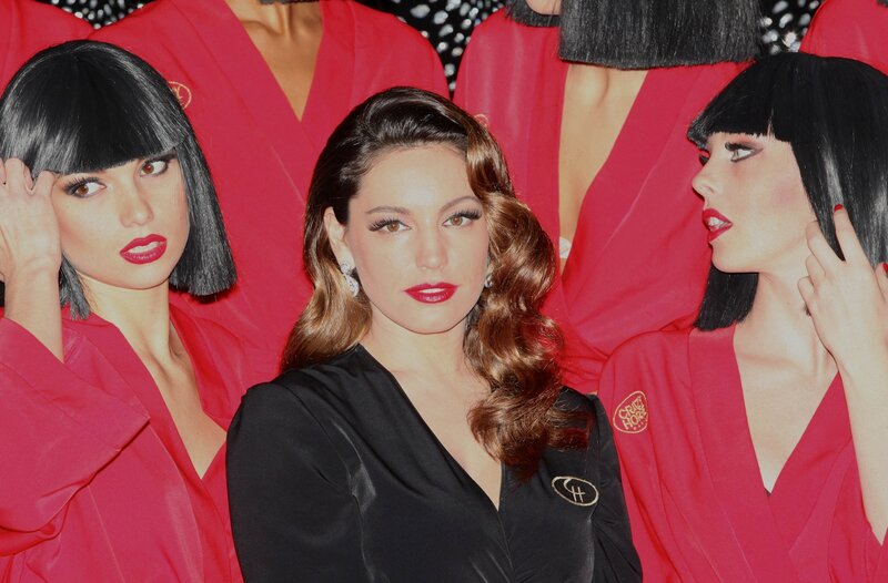 woman with models in red robes