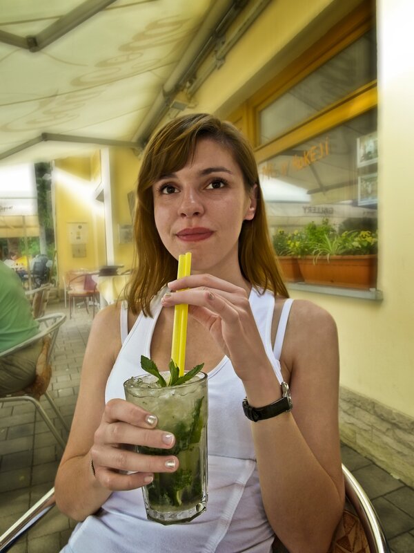 Woman with mojito at outdoor cafe