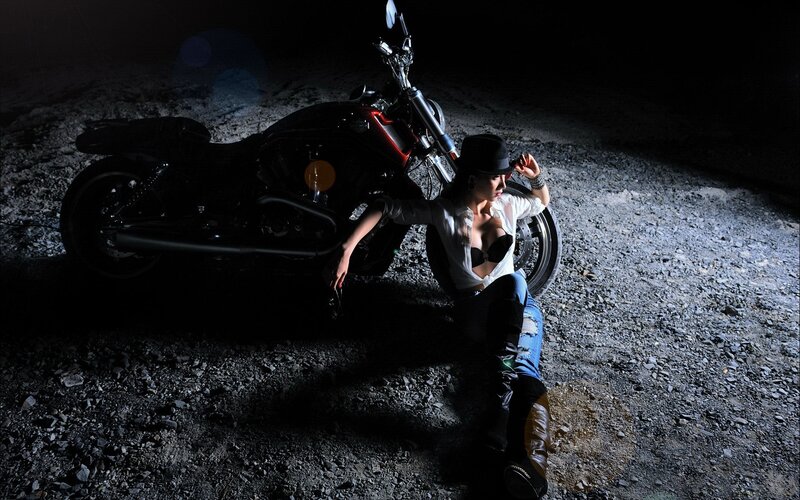 woman with motorcycle at night