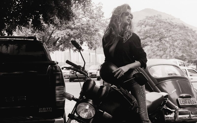 Woman with motorcycle in city