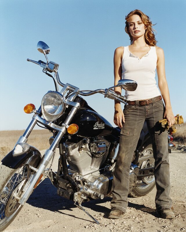 woman with motorcycle in desert
