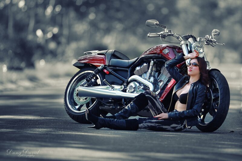 woman with motorcycle on road