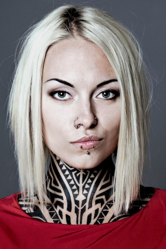 woman with neck tattoos and piercings