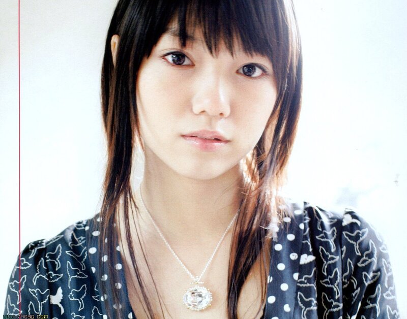 woman with necklace and patterned top