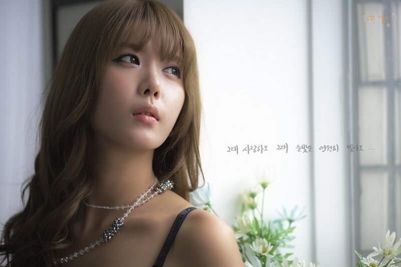 woman with necklace by window