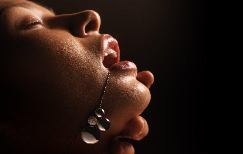 woman with necklace in profile