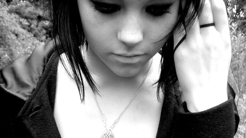 woman with necklace looking down
