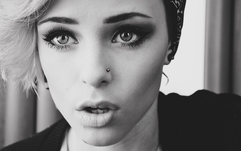 woman with nose piercing and bold makeup