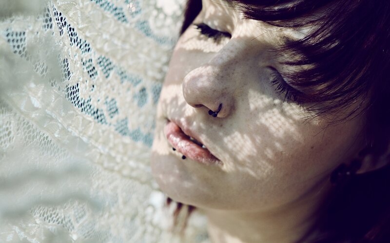 woman with nose piercing in sunlight