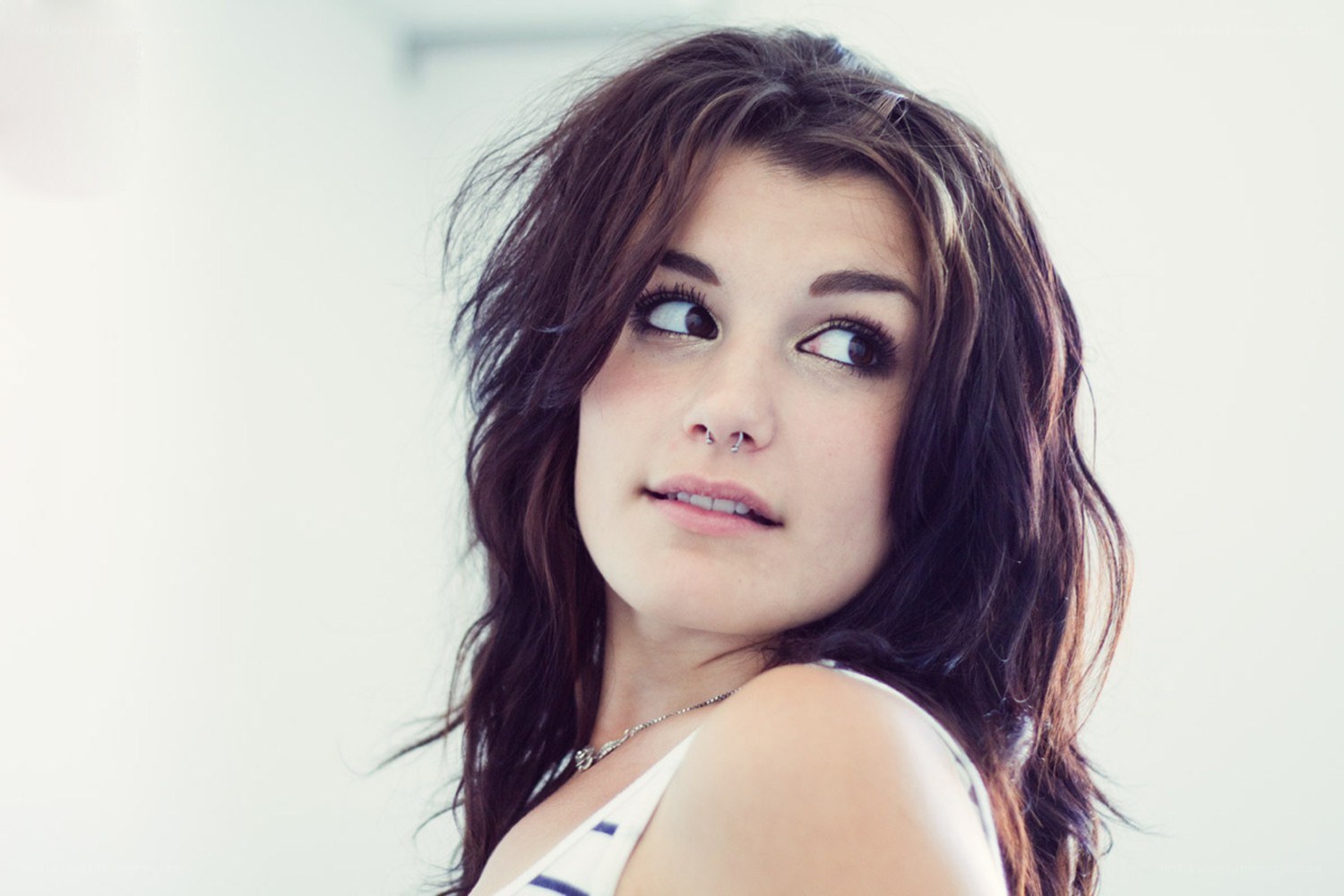 woman with nose piercing looking up