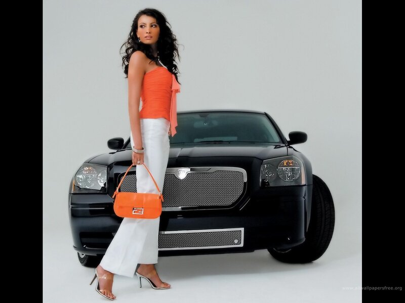 woman with orange bag and black car