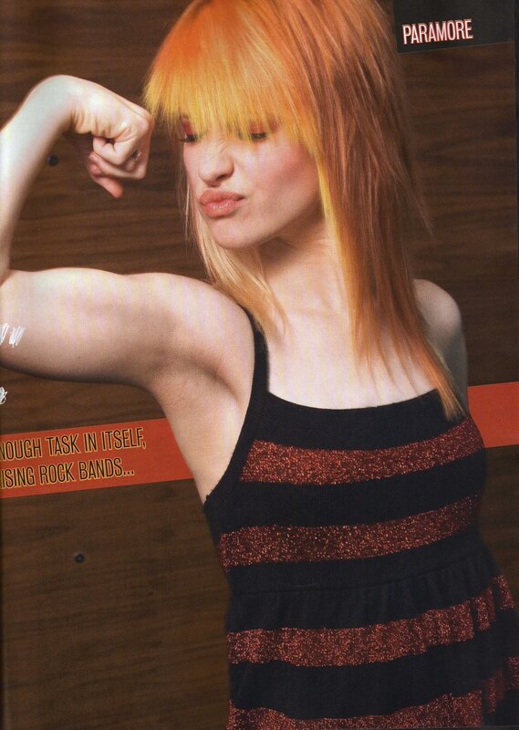 woman with orange hair flexing