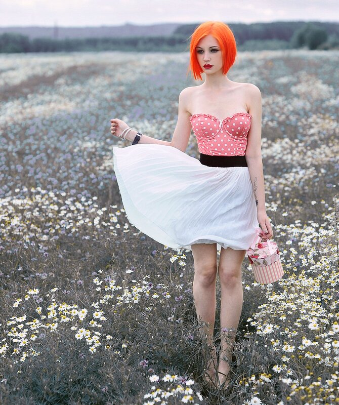 Woman with orange hair in a flower field