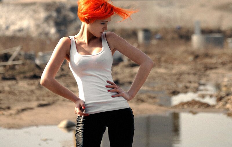Woman with orange hair in a wasteland