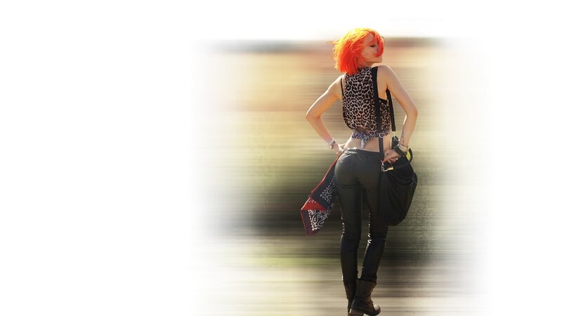 woman with orange hair walking