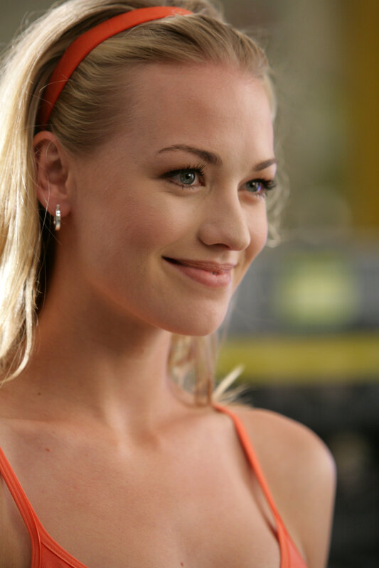 woman with orange headband smiling