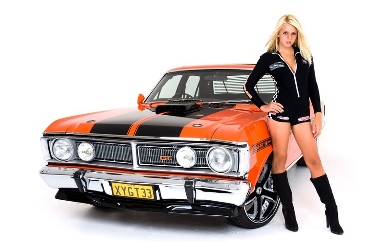 Woman with orange muscle car