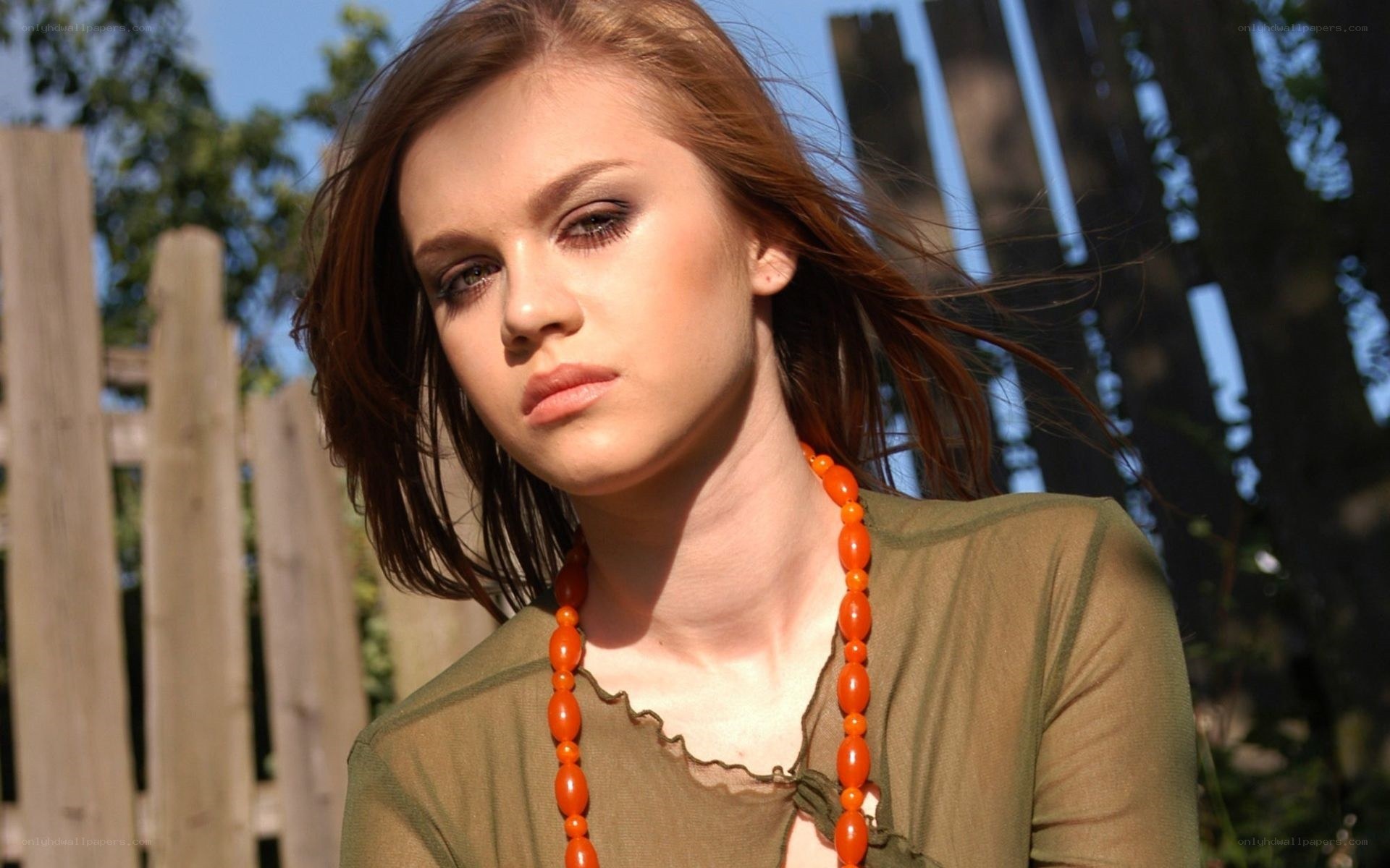 woman with orange necklace