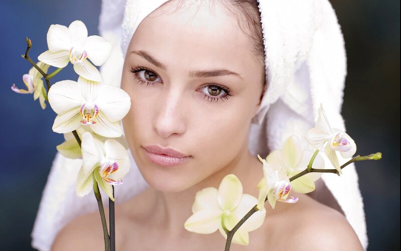 woman with orchids and towel