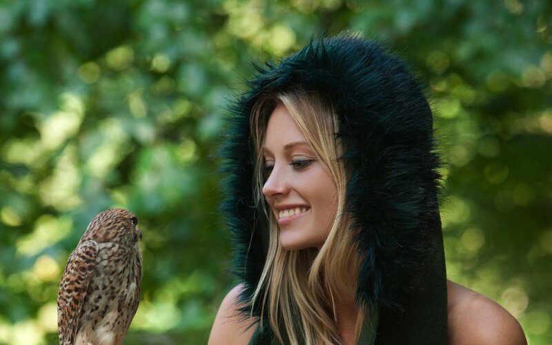 Woman with owl in forest