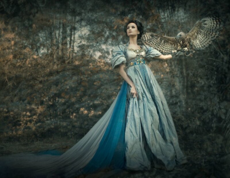 Woman with owl in forest