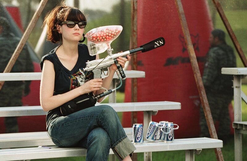 Woman with paintball gun on bench