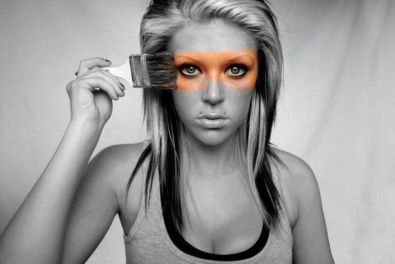woman with paintbrush on face