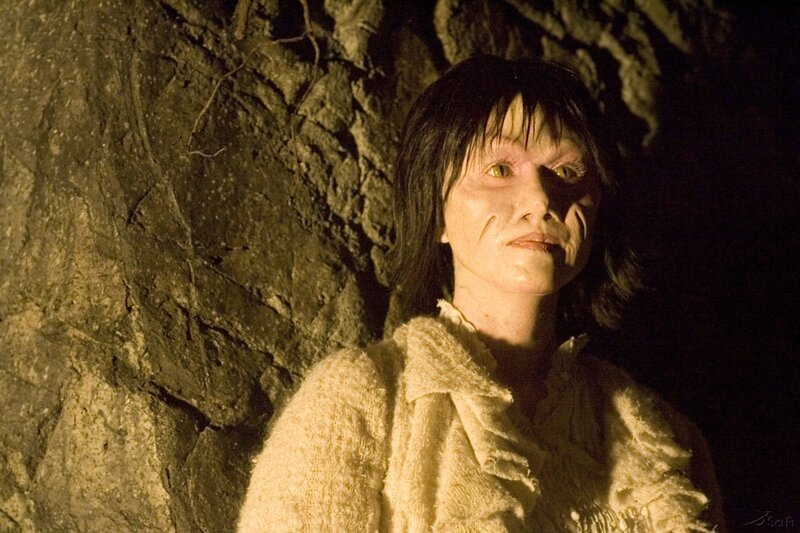 woman with pale face in cave