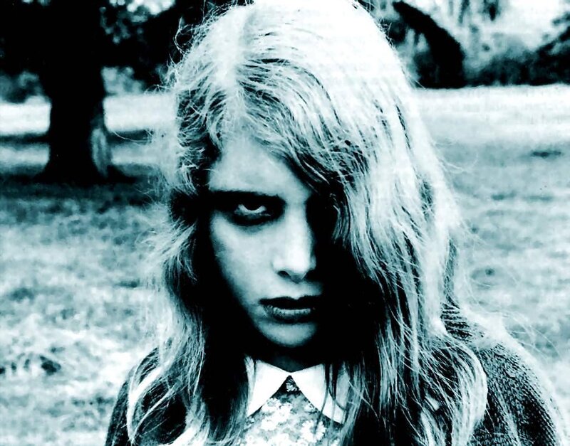 woman with pale makeup in park