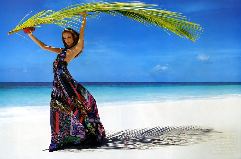 woman with palm leaf on beach