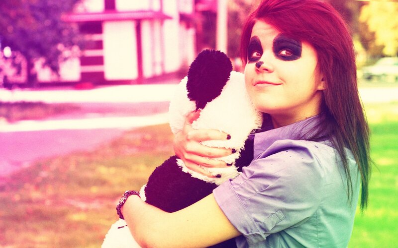 woman with panda makeup holding toy